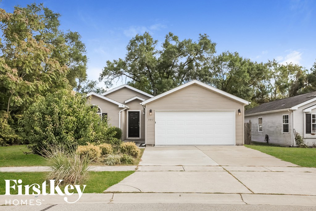 a single story home with a white garage door