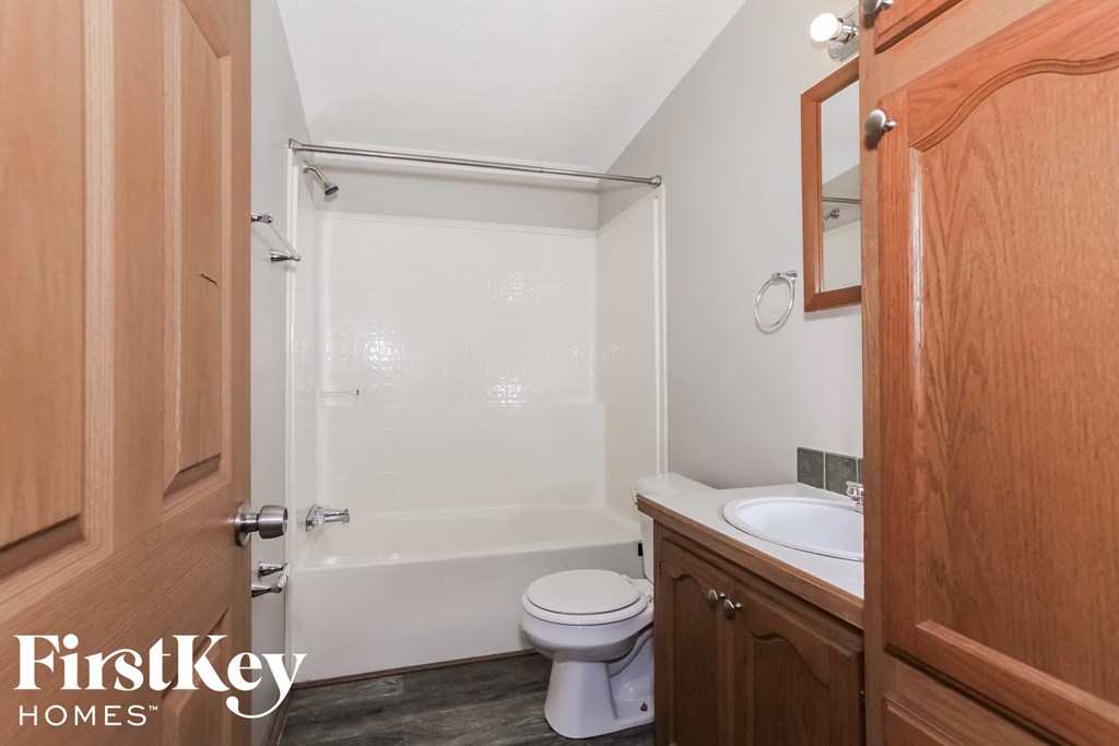 a bathroom with a toilet and a sink and a shower