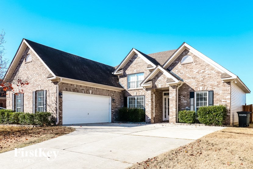 A house with a garage and a driveway in front.