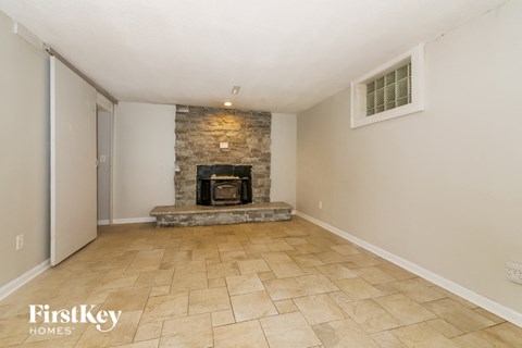 the living room has a fireplace and tile flooring