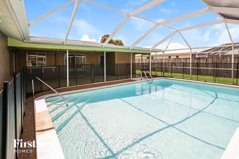 A swimming pool under a white roof.
