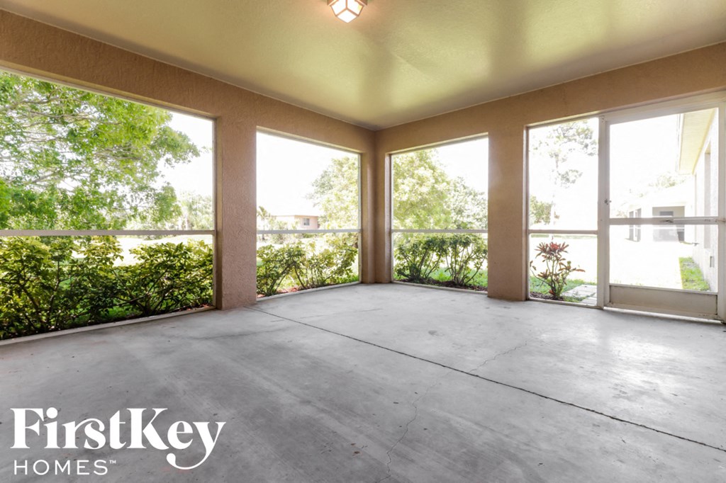 A large empty room with a FirstKey Homes logo.