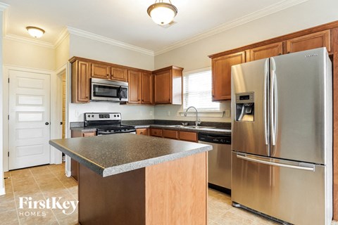 a kitchen with stainless steel appliances and granite counter tops