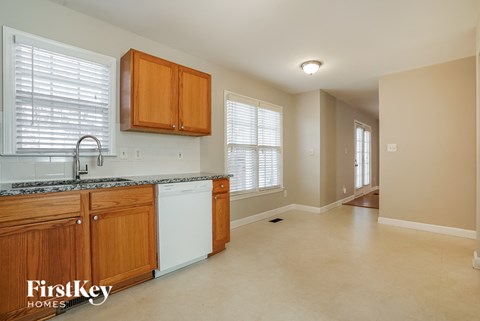 A kitchen with wooden cabinets and a granite countertop.