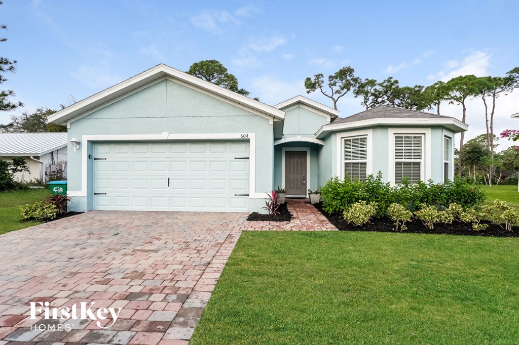 A house with a blue garage door is for sale.