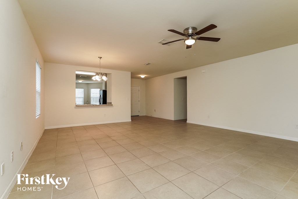 A spacious room with a ceiling fan and a window.