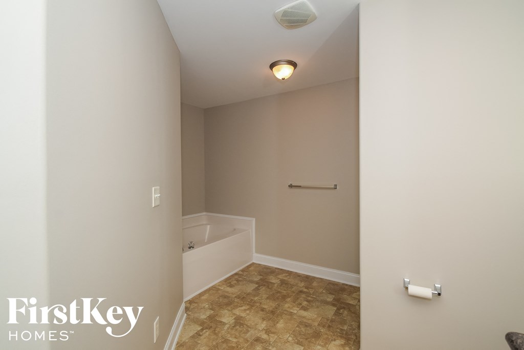 a small bathroom with a tub and a toilet in it