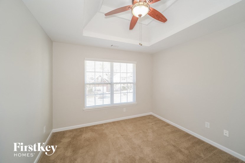 a living room with a ceiling fan and a window