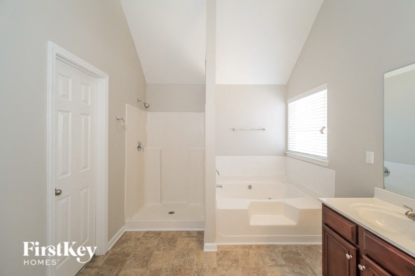 the master bathroom has a soaking tub and a shower