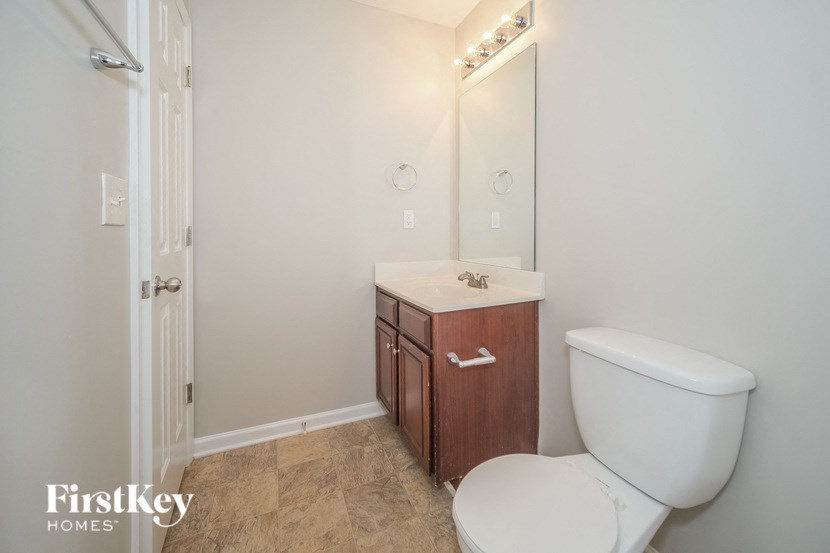 a bathroom with a toilet and a sink and a mirror