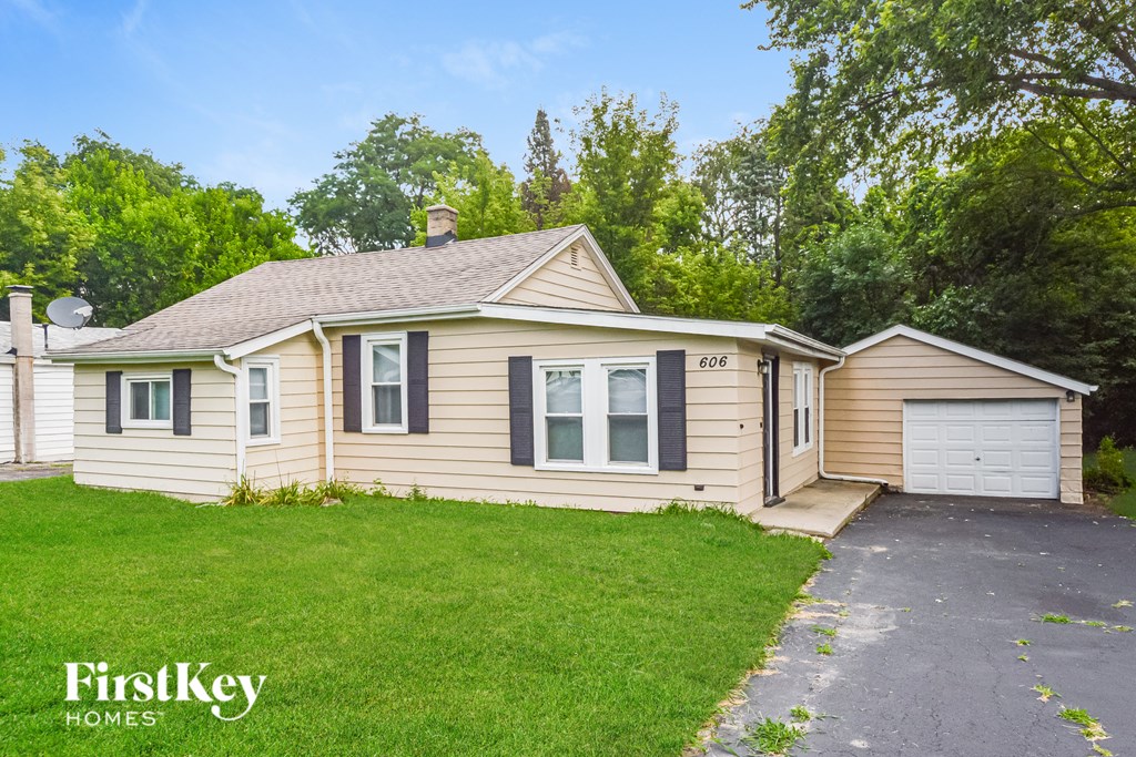 A house with a driveway and garage is for sale.