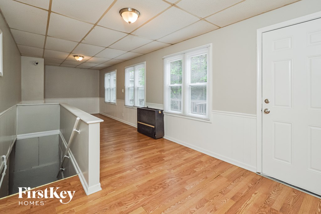 A room with wooden floors and a white door.