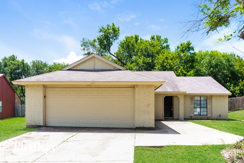 A two-car garage with a brick exterior and a gabled roof.