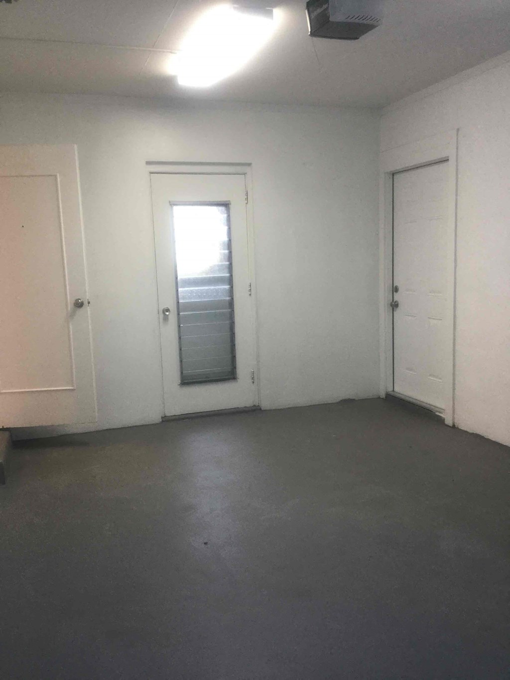 an empty room with a door in the middle of it