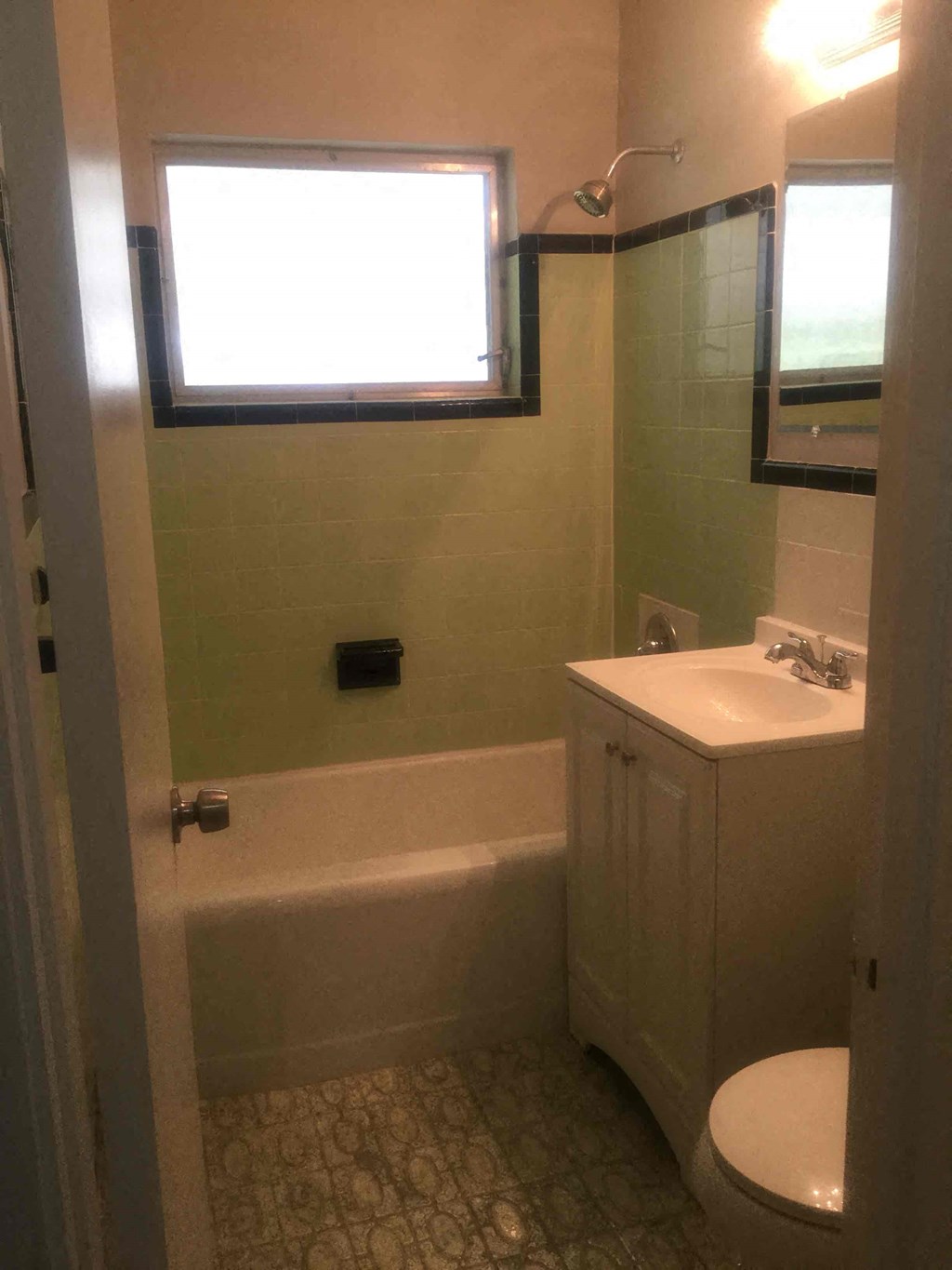 a small bathroom with a sink toilet and a bath tub