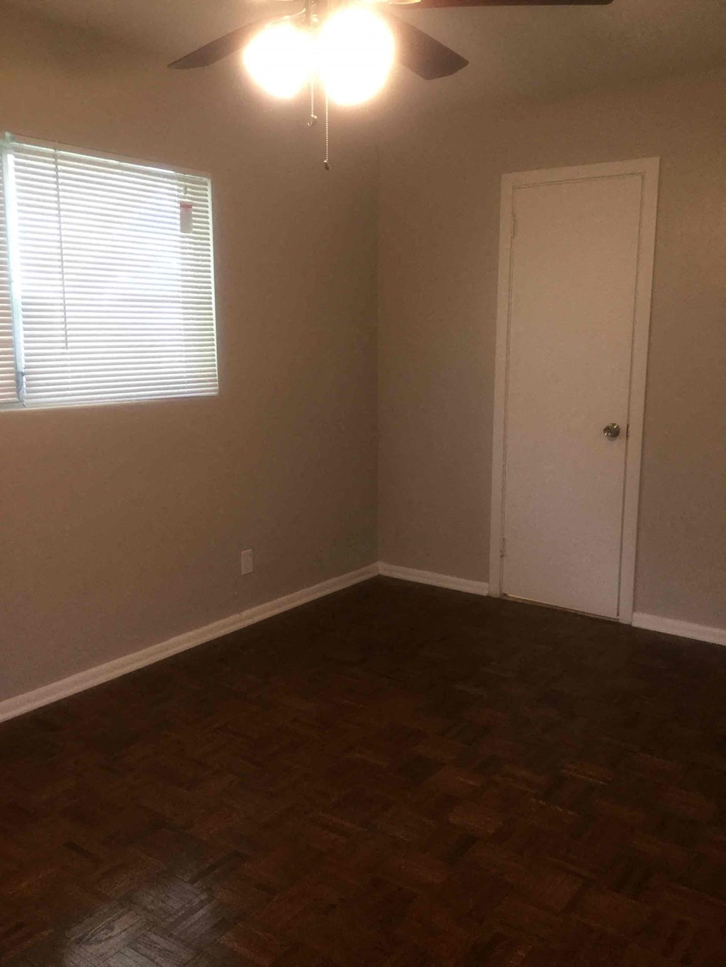 an empty room with a door and a window