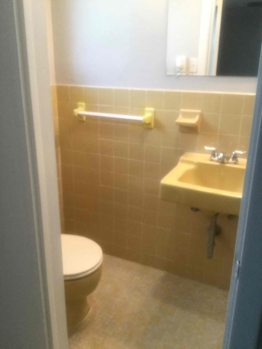 a bathroom with a toilet and a sink