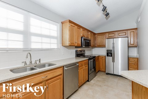 A kitchen with wooden cabinets and stainless steel appliances.