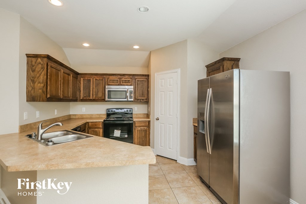 a kitchen with stainless steel appliances and wooden cabinets