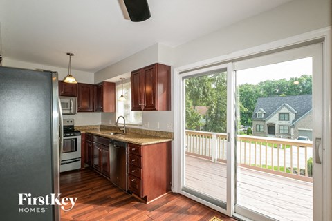 A kitchen with wooden cabinets and a refrigerator.