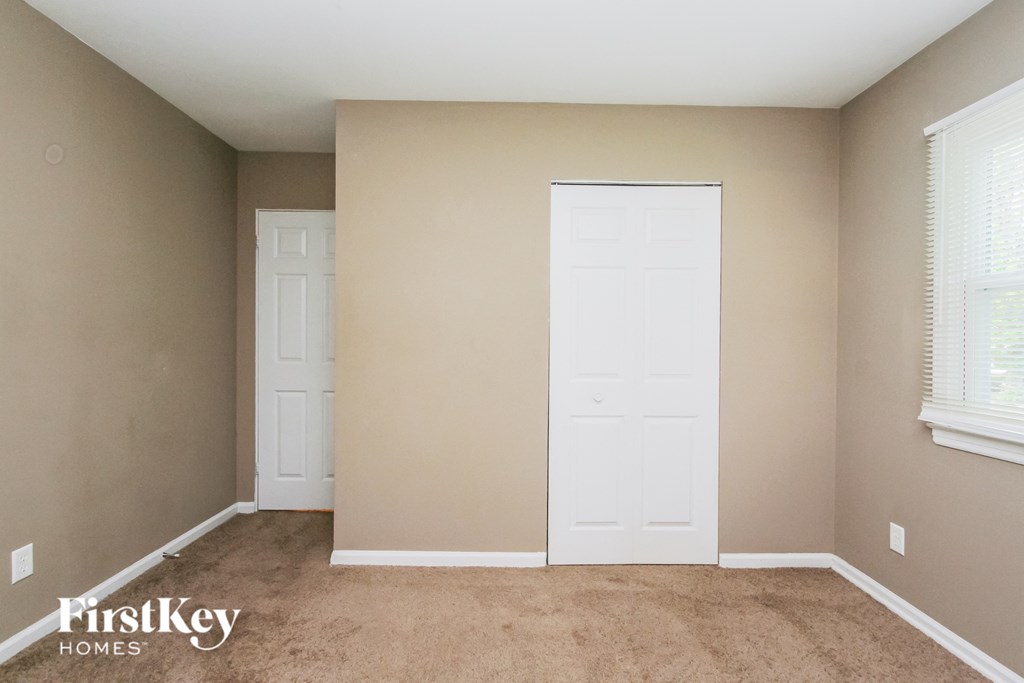 a room with two white doors and a carpeted floor