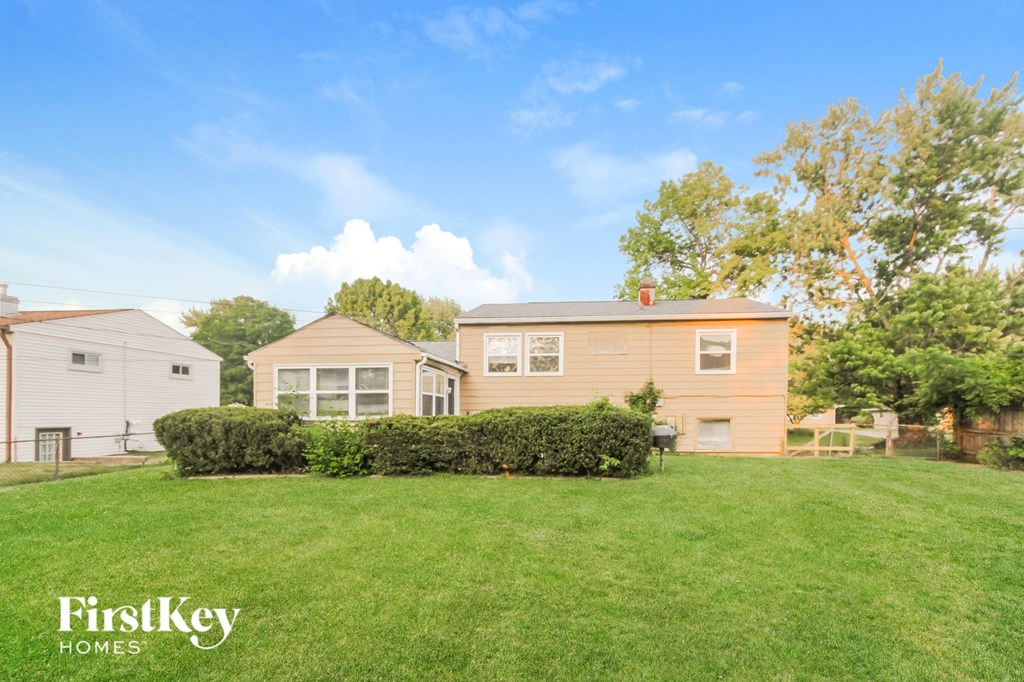 a house with a yard and a lawn in front of it