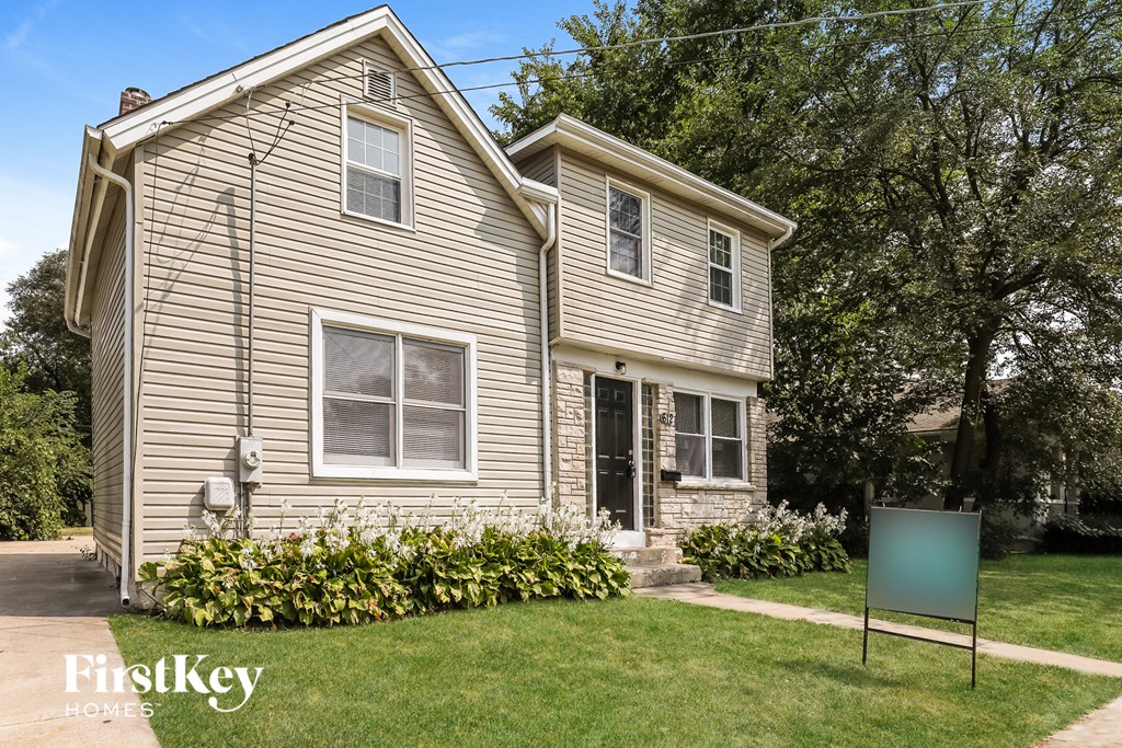 a house with a green sign in front of it