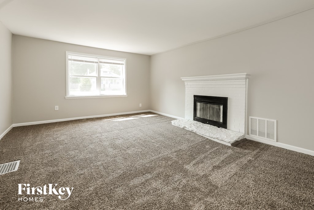 a clean and empty living room with a fireplace