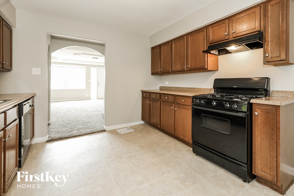 a kitchen with black appliances and wooden cabinets