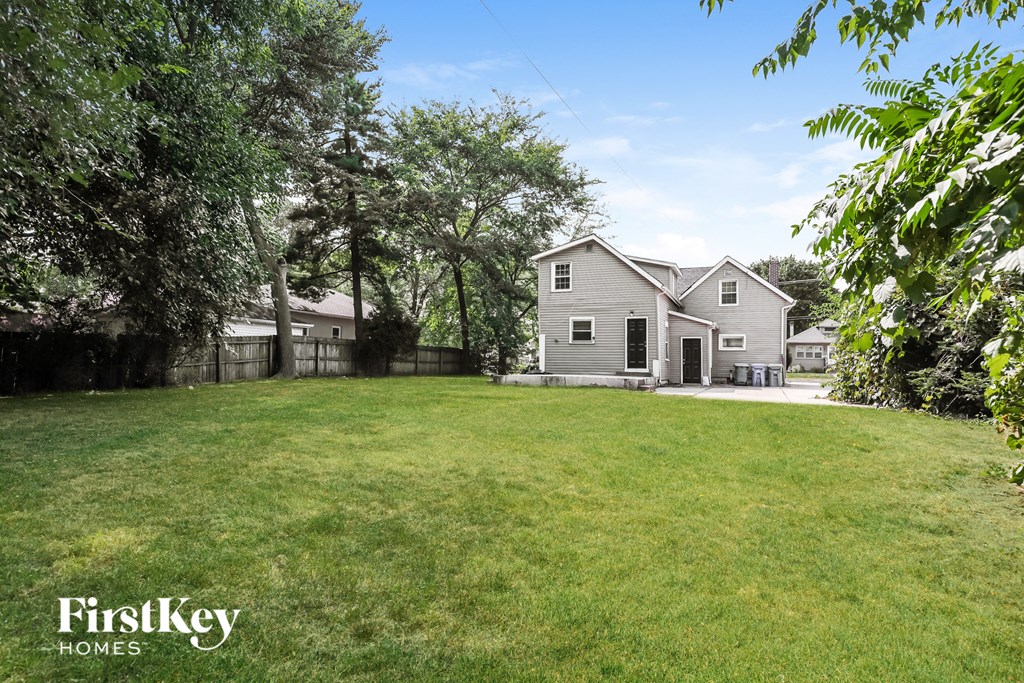 a backyard with a house and a large yard