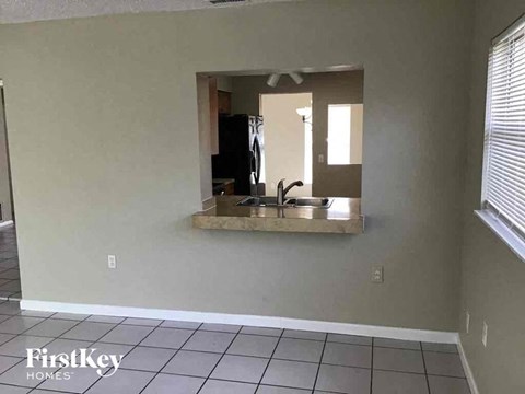 a view of a kitchen with a sink and a mirror
