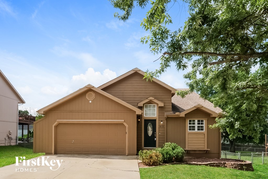 A house with a brown garage door is for sale.
