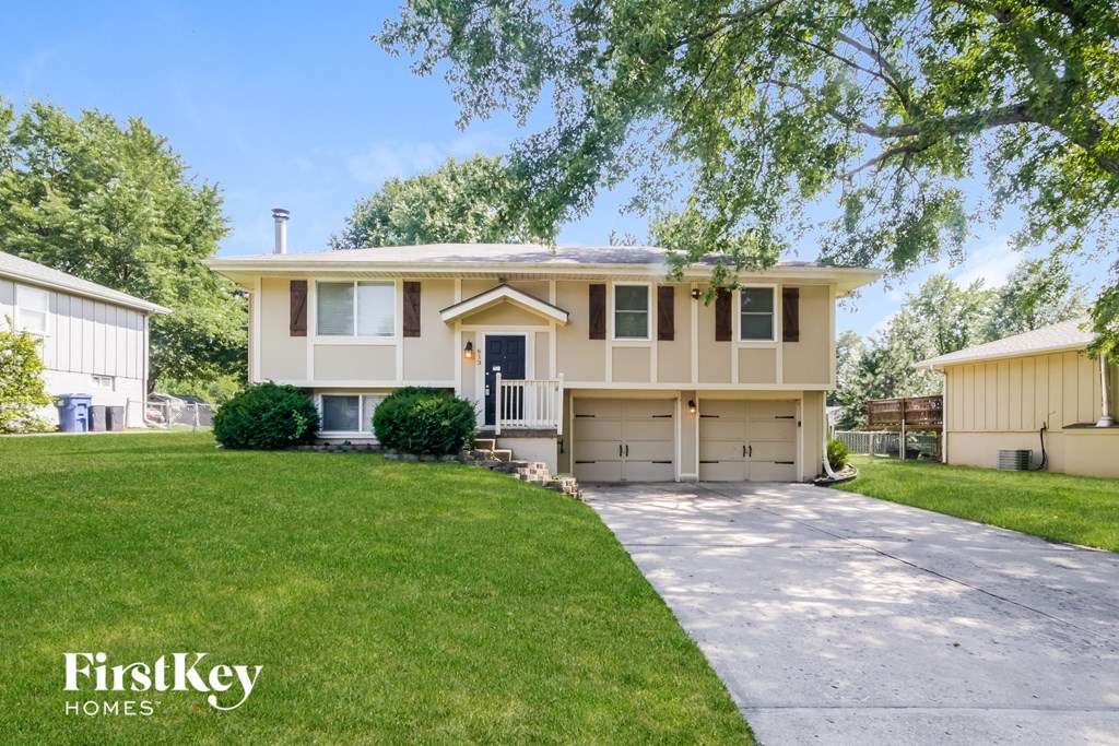 A two-story house with a garage is for sale.