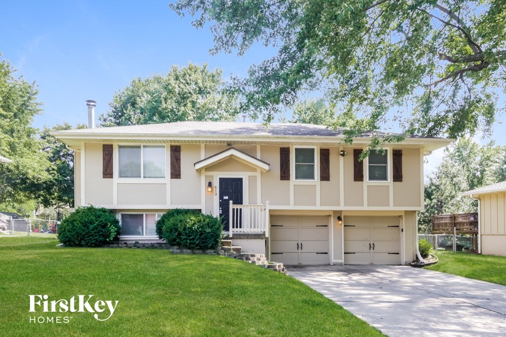 A two-story house with a garage is for sale.