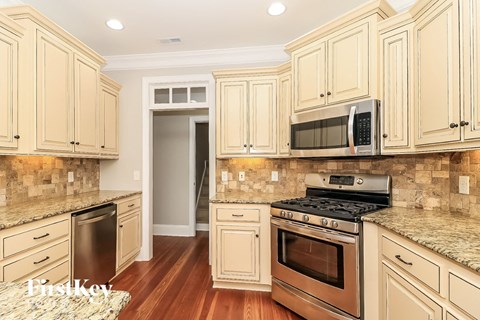A kitchen with wooden cabinets and a granite countertop.