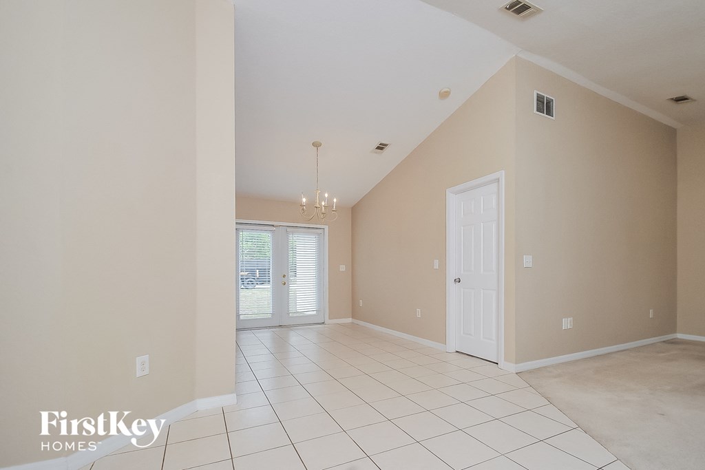 the living room and dining room with the door to the patio