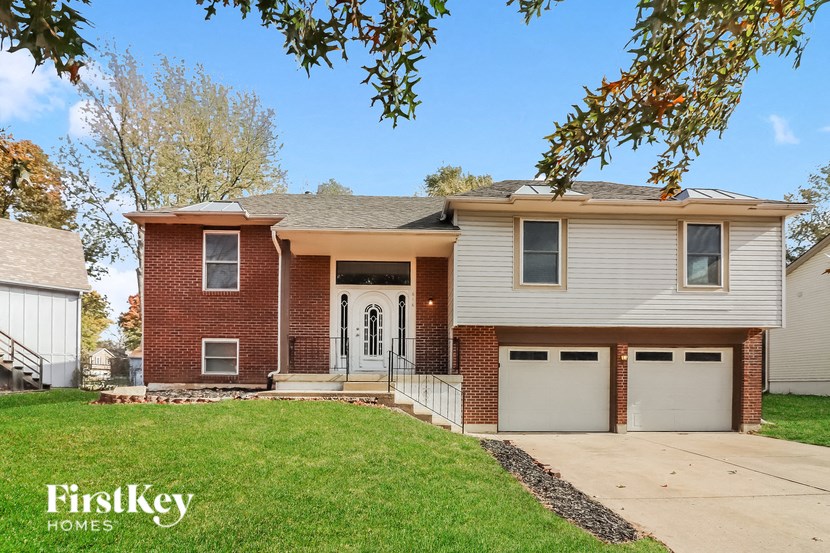 A two-story house with a garage is for sale.