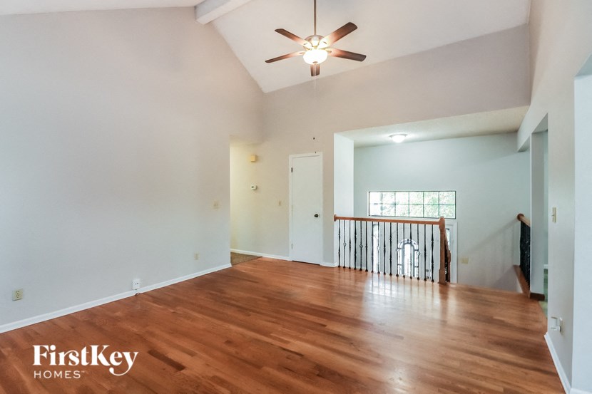 A room with wooden floors and a ceiling fan.