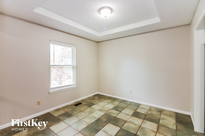 A room with a checkered floor and a window.