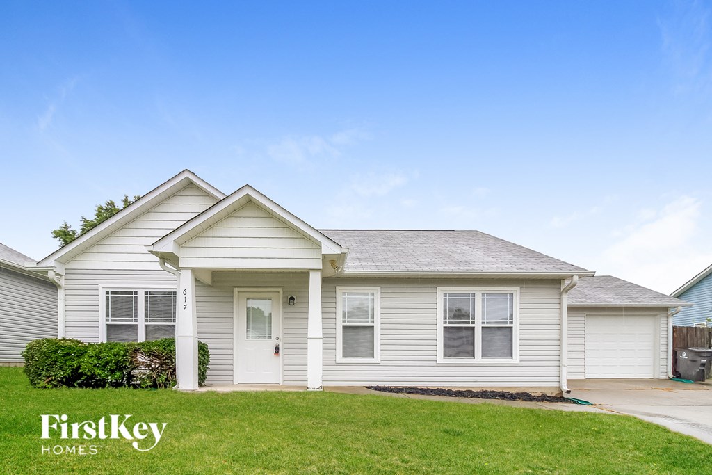 a white house with a lawn in front of it