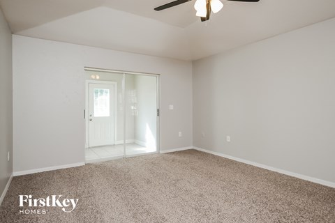 a master bedroom with carpet and a door to the bathroom