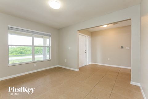 A room with a sliding glass door and a tiled floor.