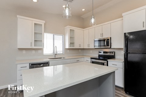 a kitchen with white cabinets and a white counter top