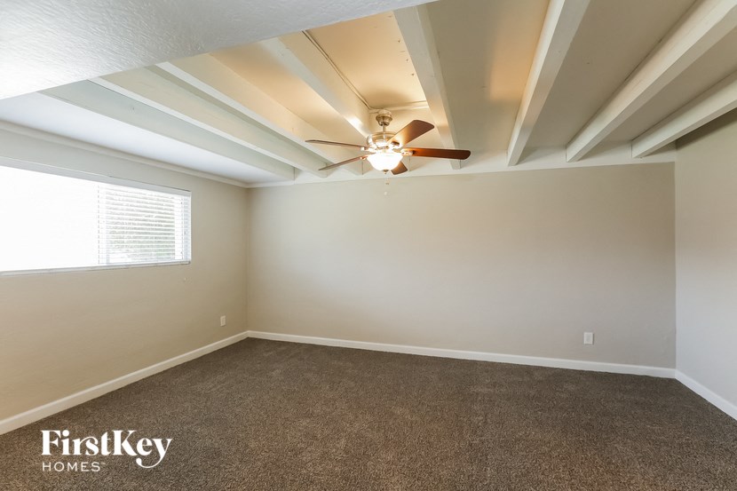 the living room of a home with a ceiling fan