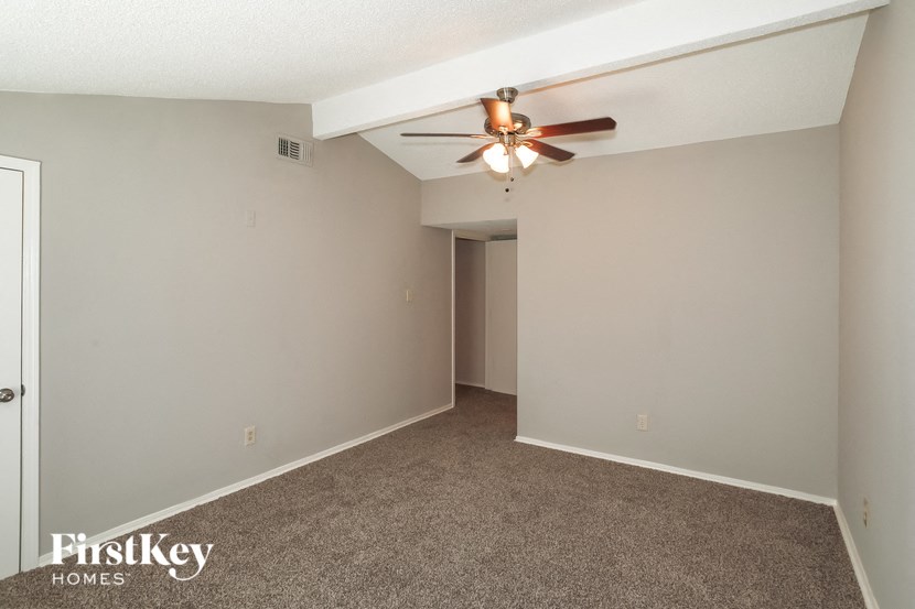 the living room of a home with a ceiling fan