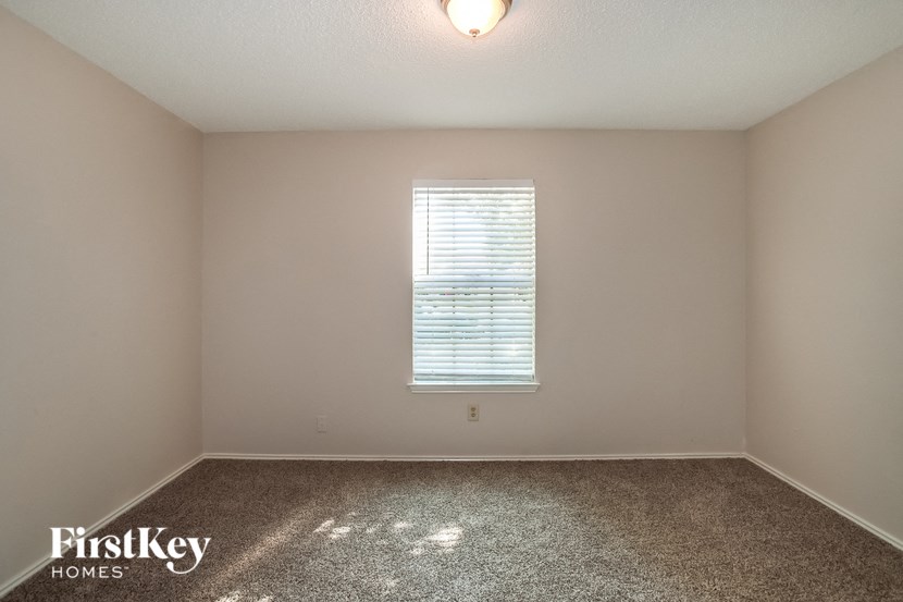 a empty room with a window and carpet