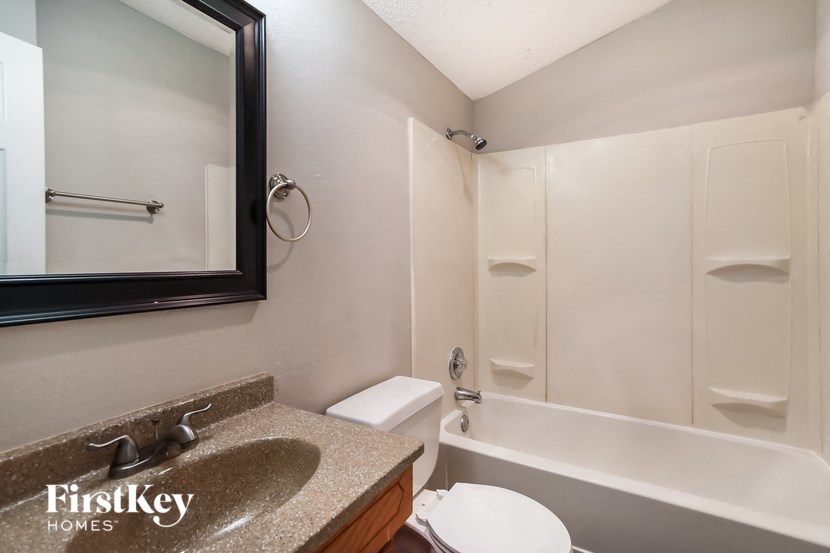 a bathroom with a sink and a toilet and a bath tub