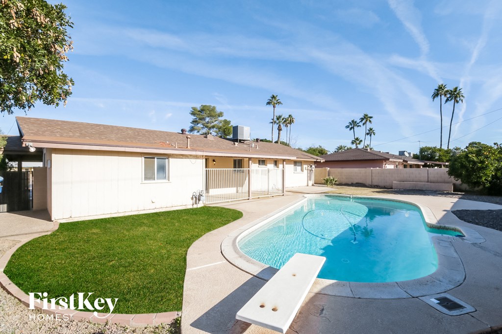 A house with a pool in the backyard.