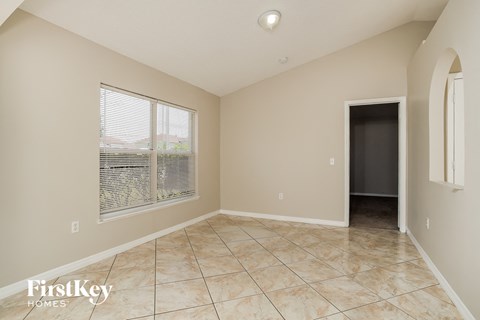 the living room of an empty house with a large window