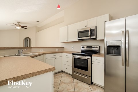 a kitchen with stainless steel appliances and white cabinets
